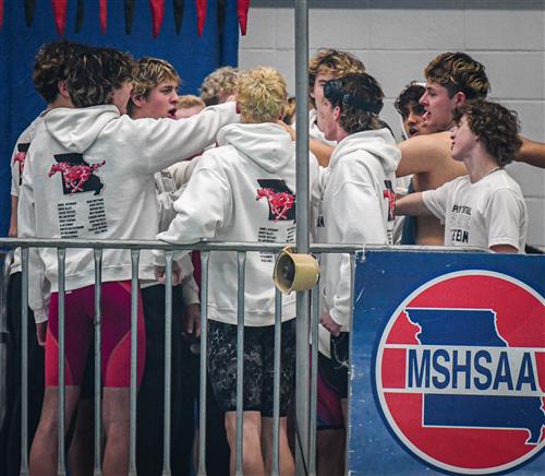 Central High boys swimming team huddle